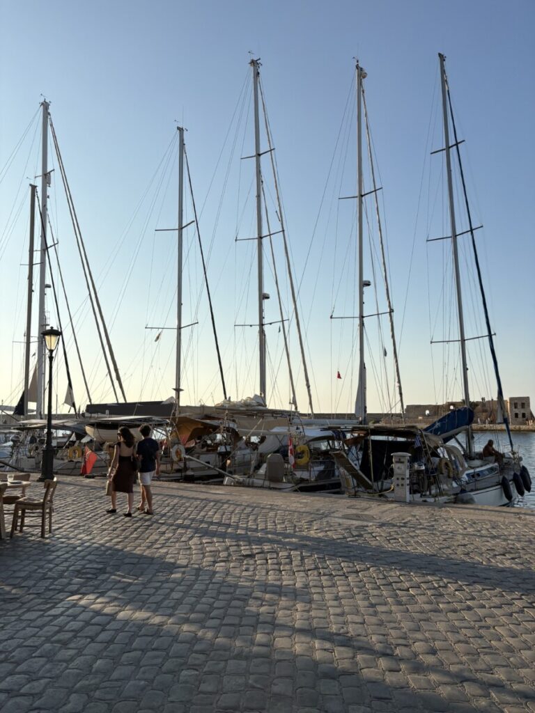 Sailboat masts in a harbor at golden hour
