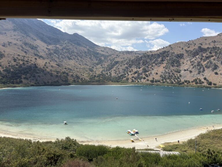 Turquoise lake surrounded by mountains, seen through a window
