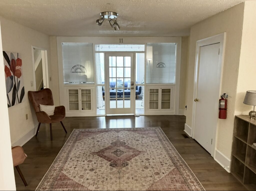 Waiting area at Born to Bend's Asheville office with armchairs and glass doors into the office