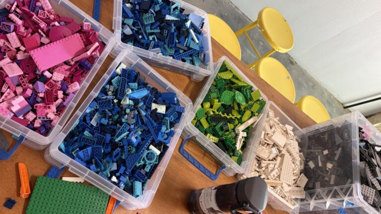 Colorful building blocks sorted into bins